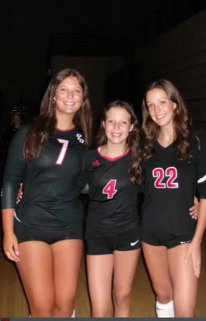 Sadie, Ellis and Sloan side by side in their black and red volleyball uniforms.