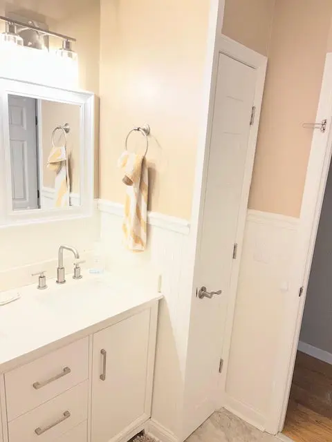 New six-panel door and trim beside the vanity.
