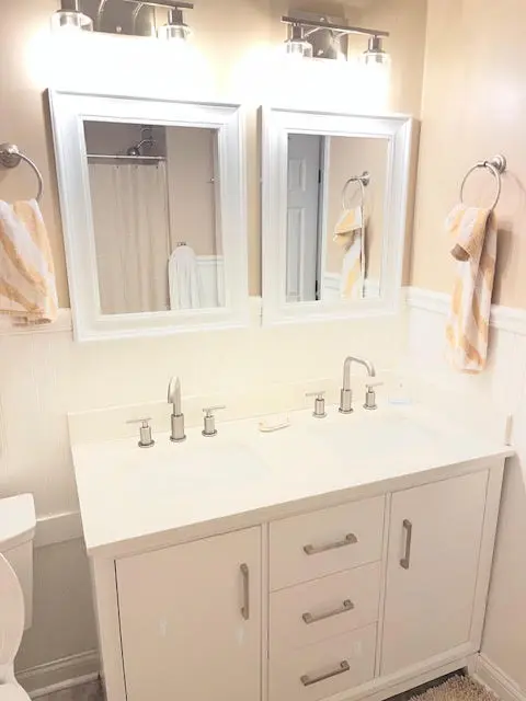 Close view of the new faucets and the light bars above the mirrors.
