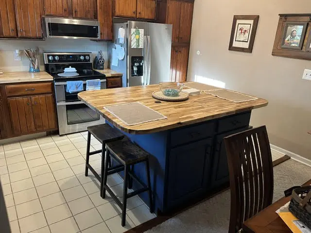 The island after: navy painted base, butcher block top, and new stools.
