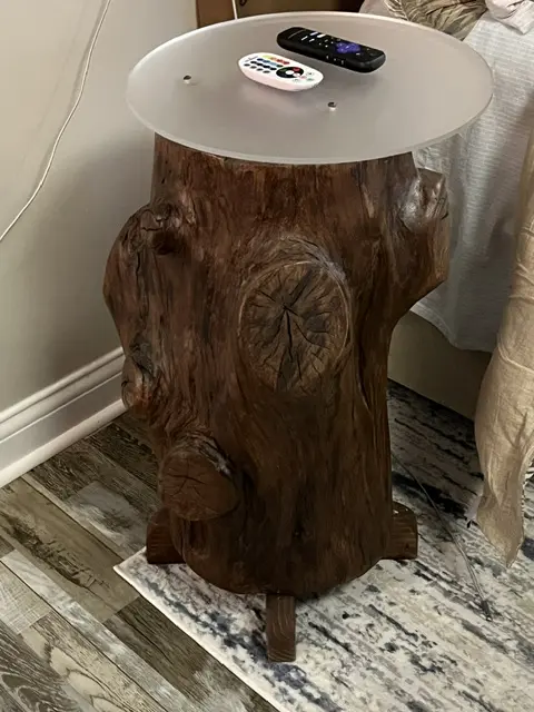 A live-edge white oak slab finished as a side table top, with the bark edge and a knot left in.